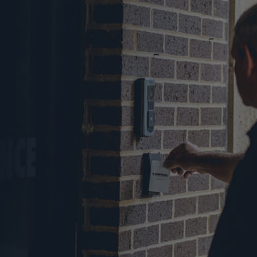 man using a electronic key card to gain access to building