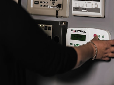 woman activating door lock security system