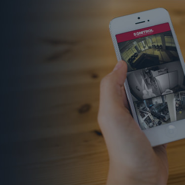 hand holding a smartphone watching video security system for business and properies